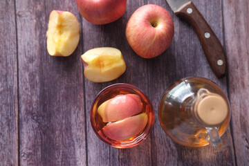 apple vinegar in glass with fresh apple on table , top view 
