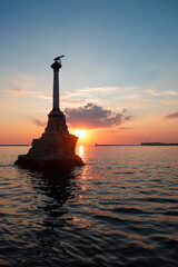 Fototapeta premium sunset over the sea with Monument to the Sunken Ships