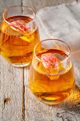 glass of apple juice and sliced apples on a table