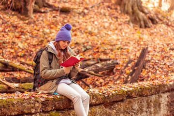 Woman reading a book in the forest