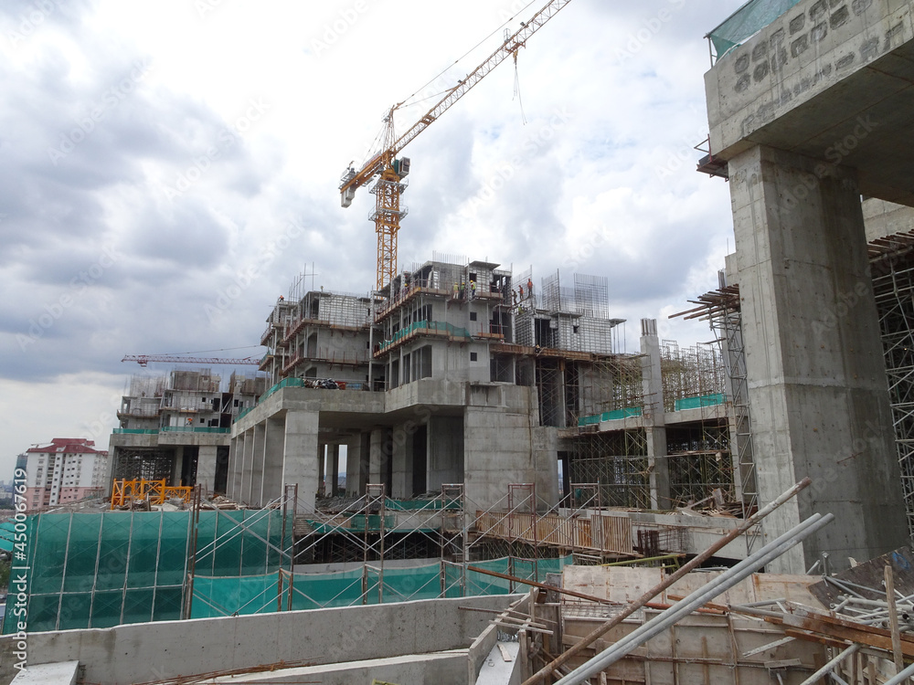 Wall mural PENANG, MALAYSIA -JUNE 18, 2021: Structural works are underway at the construction site. Construction workers are installing formwork made of metal or timber. Safety features are paramount.
