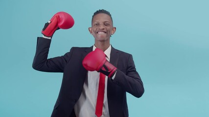 Smiling confident black man businessman shows hand in a boxing glove and pats himself on the chest and biceps. - Powered by Adobe
