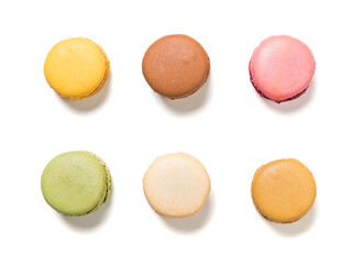 Variety of pastel colored macarons pastry, isolated on white background