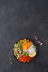 Salad with baked vegetables. Asian salad with eggplant, chili and garlic. On a black concrete background.
