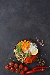 Salad with baked vegetables. Asian salad with eggplant, chili and garlic. On a black concrete background.