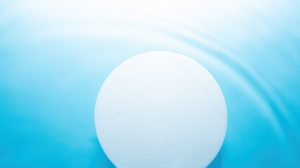 Empty white circle podium on water with waves in sunlight. layout, copyspace.Abstract background for product presentation.