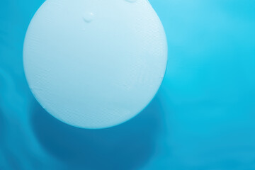 Abstract nature background for product presentation..Empty white circle podium on blue water texture with waves in sunlight. layout, copyspace