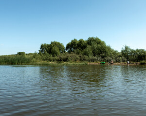 A colorful view of the lake shore on a summer day.