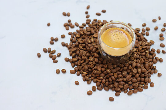 Americano Espresso coffee beans on cup topview on white background © noizstocker