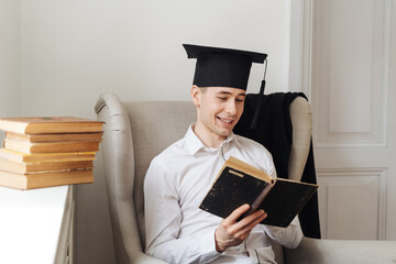 Education, graduation and people concept - smart male student with a bunch of books