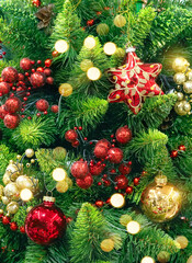 Background for classic Christmas and New Year card with bright red and gold toys on green branches of Christmas tree. Christmas lights create festive mood.