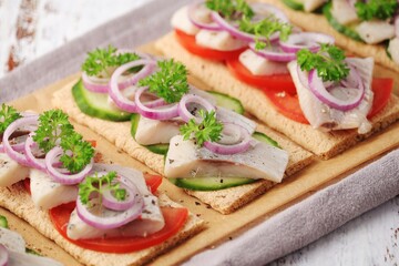 Sandwiches with herring and vegetables