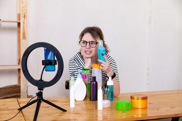 Portrait of   pretty teenage blogger girl with care cosmetics