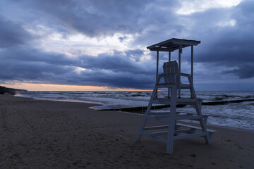 cloudy sunset over the sea and lifeguard stand