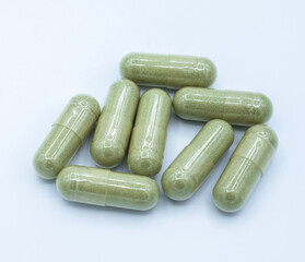 Andrographis paniculata capsules on white background. Andrographis paniculata it is a medicinal plant used in remedies of Thai traditional medicine for decades.