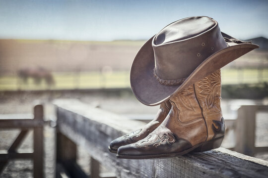 Cowboy hat and boots at ranch stables, country music festival live concert or line dancing concept