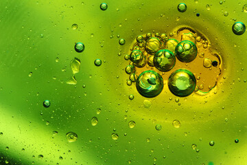 oil bubbles with water on glass