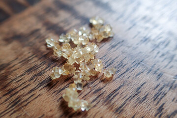 Macro selective focus. Sugar falling on a wooden table. There is space to enter text.