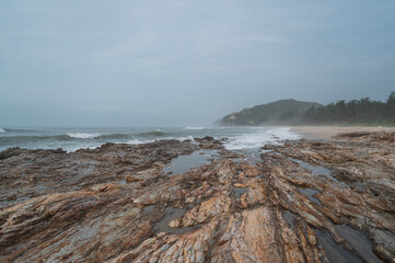 Cloudy seaside, rocks on the beach