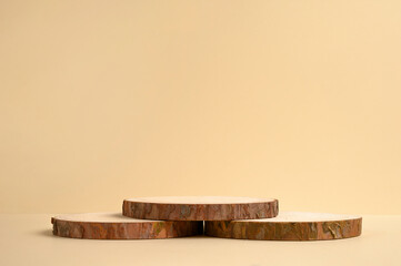 Round wooden podium on beige background for product.