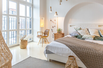 Fashionable modern interior of a light studio apartment with wooden columns in the loft style,...