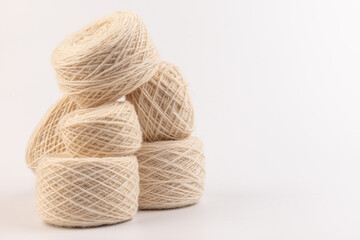 balls of light woolen thread on white background. natural wool. knitting. background