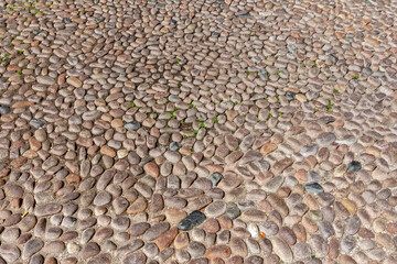 Pebble pavement in Bologna on a summer day