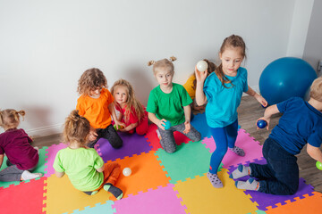 Energetic youngsters throwing away many colorful balls