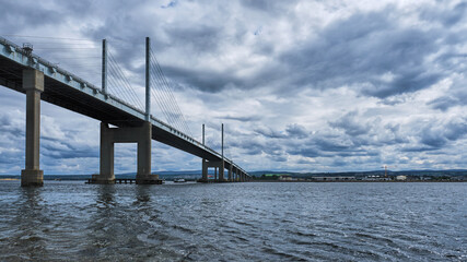 Kessock Bridge over the Moray Firth at Inverness in the Highlands with a boat sailing under the bridge