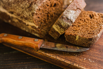 Dark multigrain cereal bread on rustic wooden board
