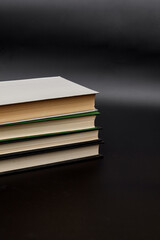 Stack of colorful books. An open book on a stack of books. The concept of education, international book day, success. Book, hardback colorful books on table. Education business concept.