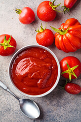 Homemade tomato sauce in gray bowl. Cooking from summer vegetables concept.