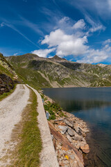 Panorama from the Gotthard pass in Ticino of the Swiss Alps on a summer's day with sunshine and blue skies.