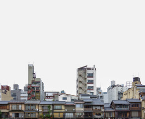 Fototapeta na wymiar traditional wooden houses and concrete buildings along Kamo River in Kyoto with white sky background