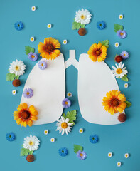 lungs with fresh green leaves and flowers as symbol of healthy lungs on blue background. World...