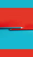 red and blue contrast pencils on red and blue background. minimalism. 