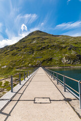 Obraz premium Panorama from the Gotthard pass in Ticino of the Swiss Alps on a summer's day with sunshine and blue skies.