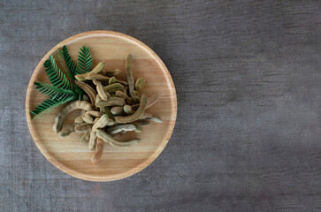 Young tamarind in a wooden tray on the wooden floor