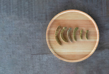 Young tamarind in a wooden tray on the wooden floor