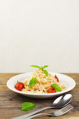 Pasta with tomato sause, cherry tomatoes and basil with copy space