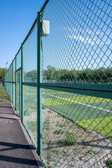 Green fence between the football field.