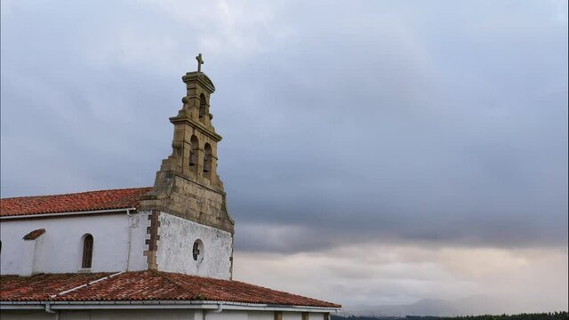 Time lapse of stormy clouds moving over old small church in north Spain. Iglesia de San Martin de Podes in Asturias.