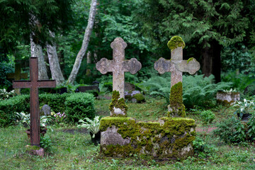 Ancient cemetery with weathered stone crosses on the quiet island of Abruka, Estonia, offering a glimpse into historical heritage and peaceful landscapes