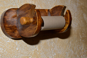 Empty toilet paper roll on a wooden hanger