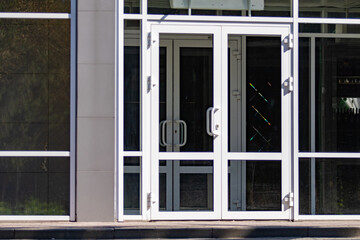 Large plastic doors, windows at the entrance to the store.