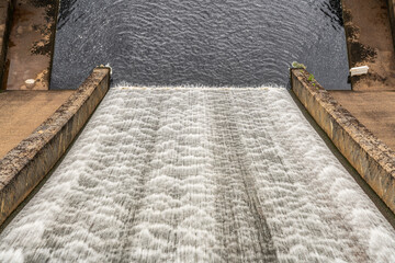 Water flowing down the dam of a reservoir