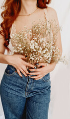 girl in bra and jeans with gypsophila