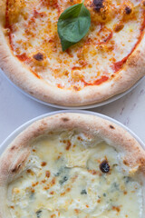 Two baked pizzas ready for lunch on a table