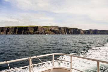 View on Cliff of Moher from a board of a ferry or cruise ship. West coast of Ireland. Popular...
