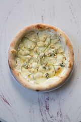 Whole neapolitan pizza with pears and cheese